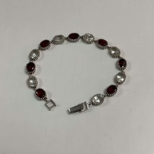 Silver bracelet with red and white stones, elegant jewellery.