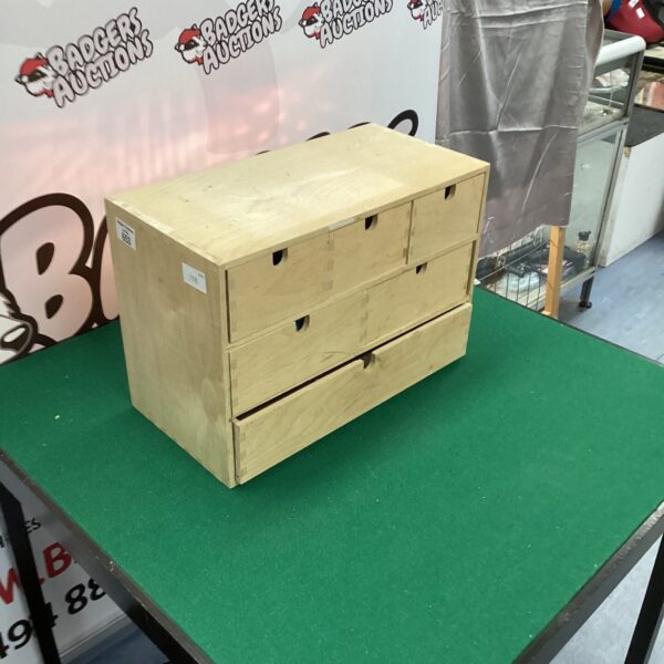 Small wooden drawer set with three graduated drawers.