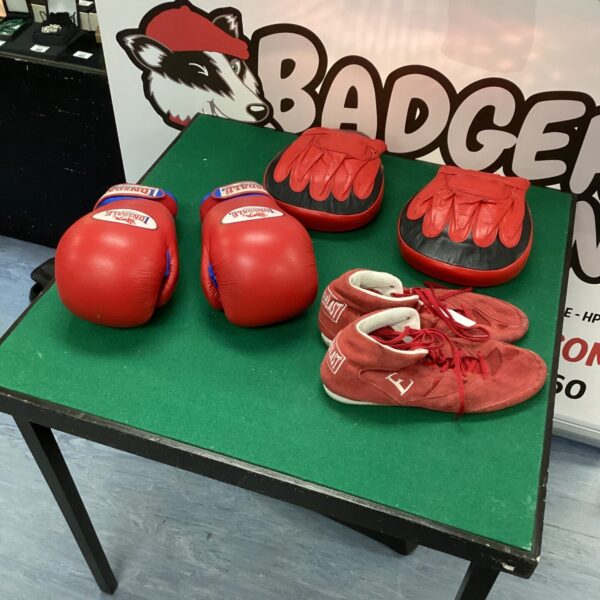 Red Lonsdale boxing gloves and training gear set for fitness.