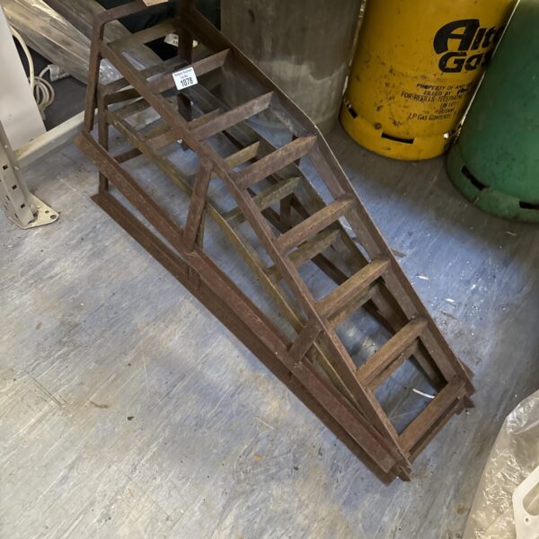 Pair of heavy-duty steel car ramps for vehicle maintenance.