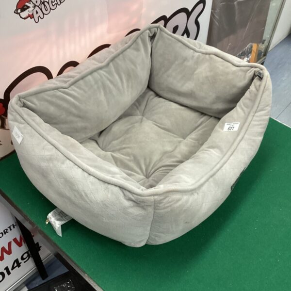 Soft circular pet bed for small dogs or cats.