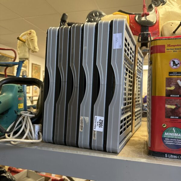 Lot of six folding plastic storage crates for household organization.