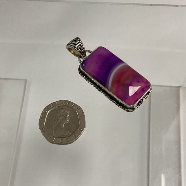 Silver pendant with a vibrant purple stone, ideal for jewellery lovers.