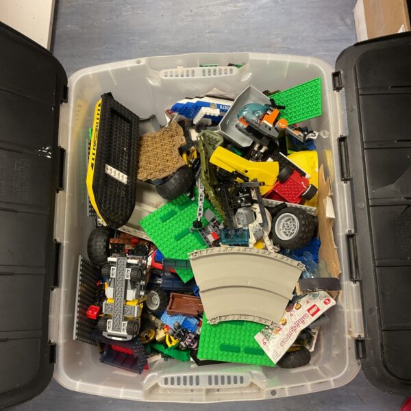 Large lot of assorted Lego bricks in a storage container.