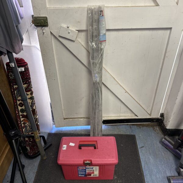 Red Contico file box with R & J wall starter kit leaning against garage door.