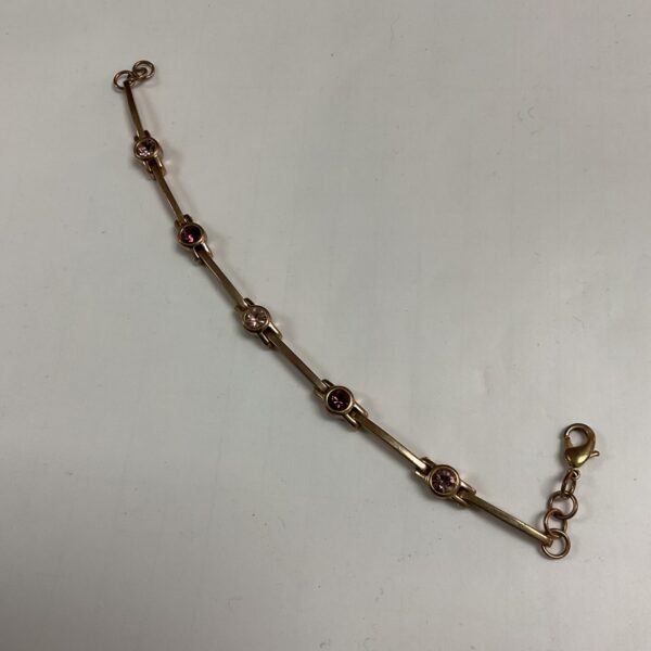 Vintage Art Deco bracelet with rose coloured stones and yellow metal links.