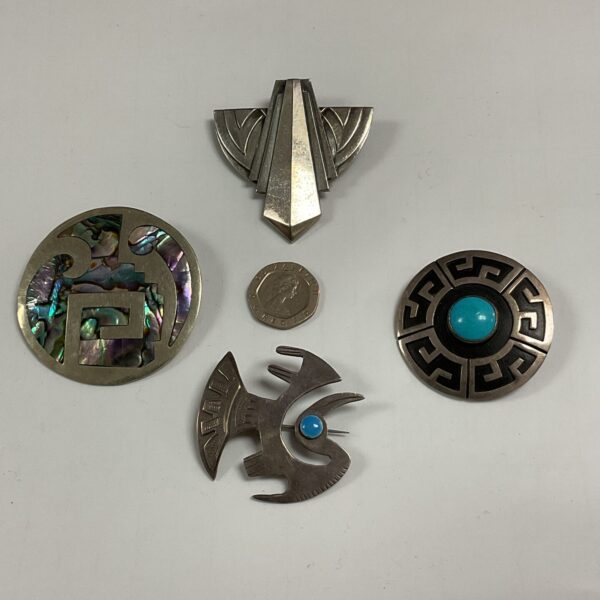 Vintage silver brooch with iridescent abalone shell inlay.