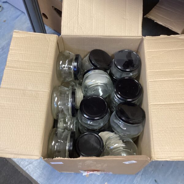 Box of new mason jars with lids for canning.