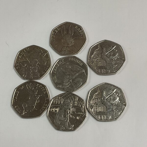 Lot of seven collectable 50p coins, including character designs.