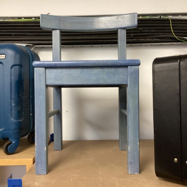 Vintage blue painted childs seat with rustic charm.