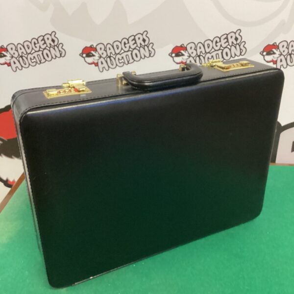 Front view of a vintage brown leather suitcase.