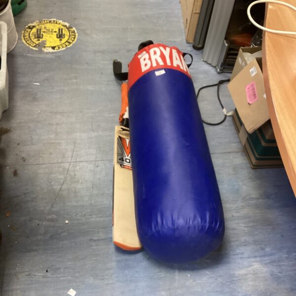 Blue punch bag with a Slazenger cricket bat in background.