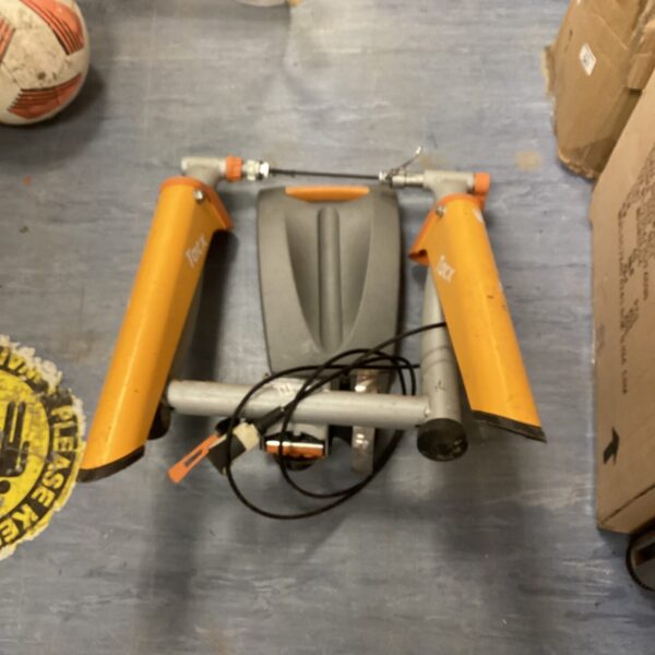Side view of a used Tacx cycle trainer for indoor cycling.