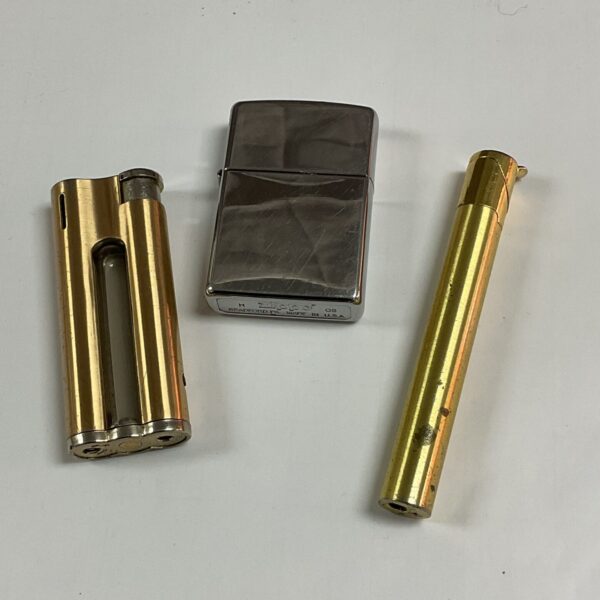Vintage Zippo lighter and gas lighters in a collectible lot.