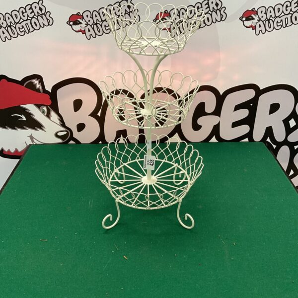 White metal tiered fruit stand for kitchen display.