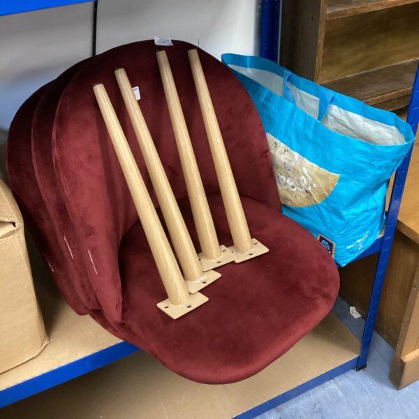 Lot of three burgundy suede designer chairs with wooden legs.