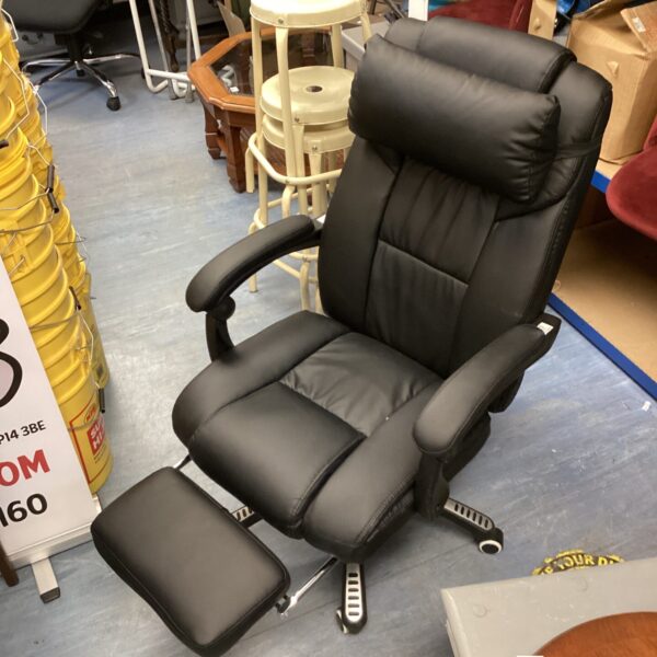 Black leather office chair with leg rest and swivel base.