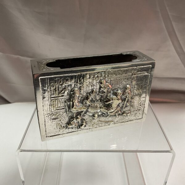 Vintage Dutch whitemetal matchbox holder with detailed relief scene.