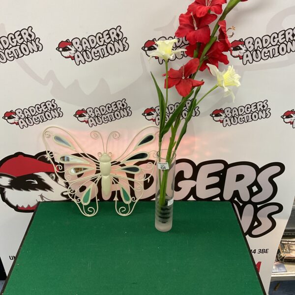 Vibrant artificial flower arrangement with butterfly wall decor.