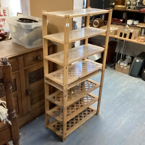 Wooden lattice shelving unit for display and storage.
