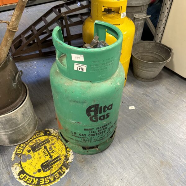 Vintage Alta gas bottle with regulator attached, showing signs of wear.