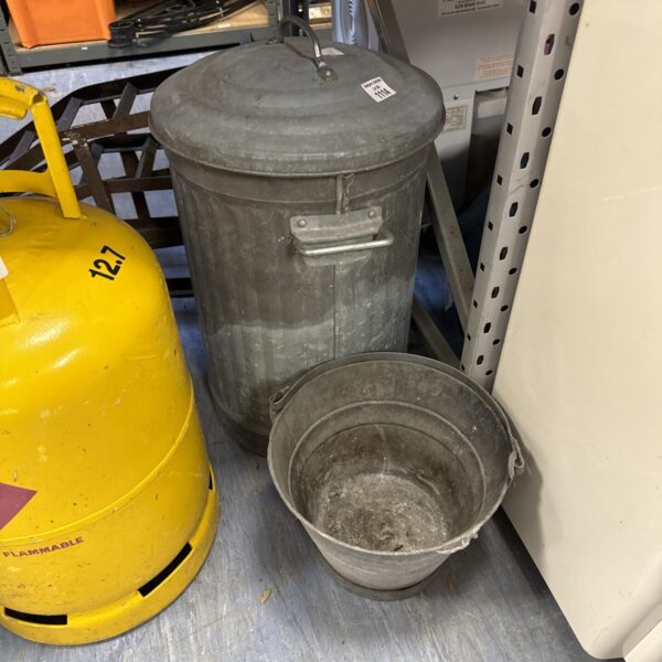 Small galvanised bucket with a worn finish, ideal for garden use.