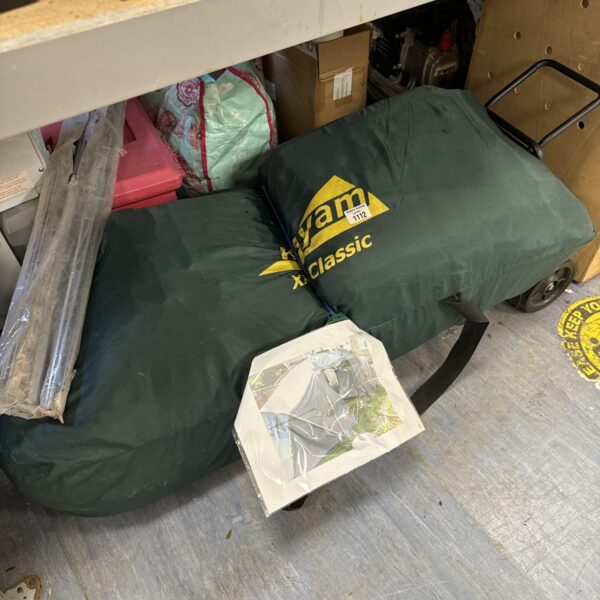 Green Khyam Classic tent packed in a bag.