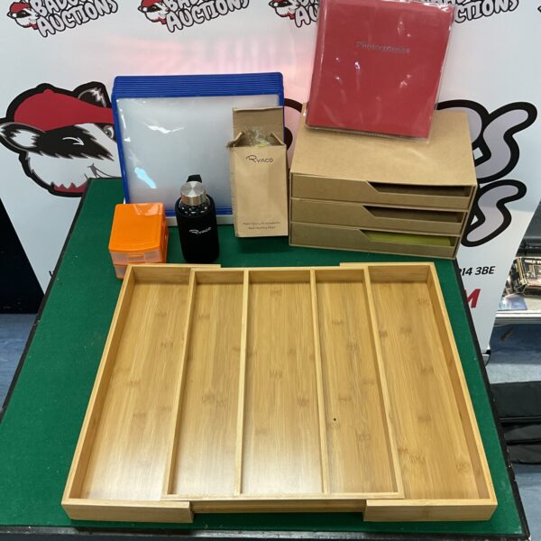 Wooden desk organiser with Ryaco bottle and stationery items.
