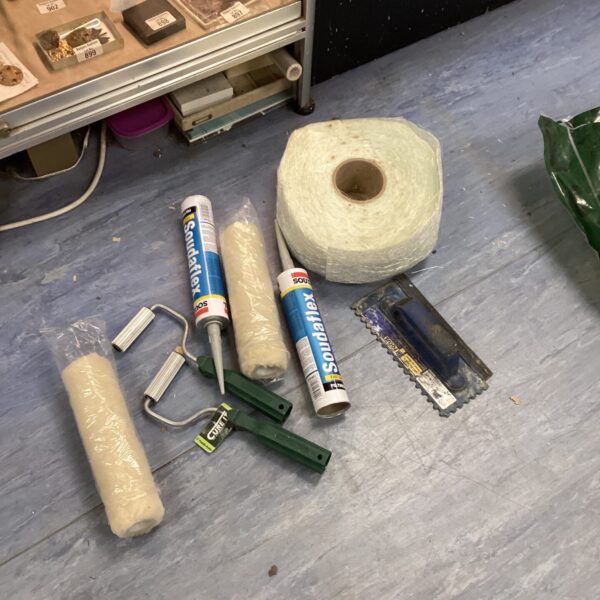 Fibreglass repair kit with rollers and adhesive for DIY projects.