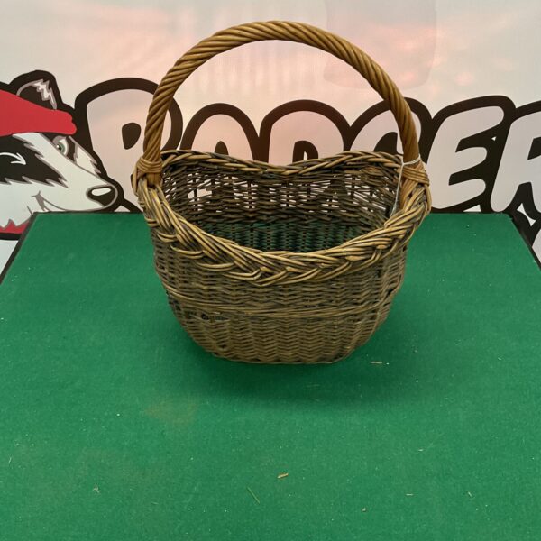 Small vintage wicker basket with a handle, ideal for storage.