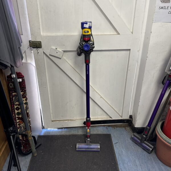 Purple Dyson V7 Animal cordless vacuum cleaner on a tiled floor.