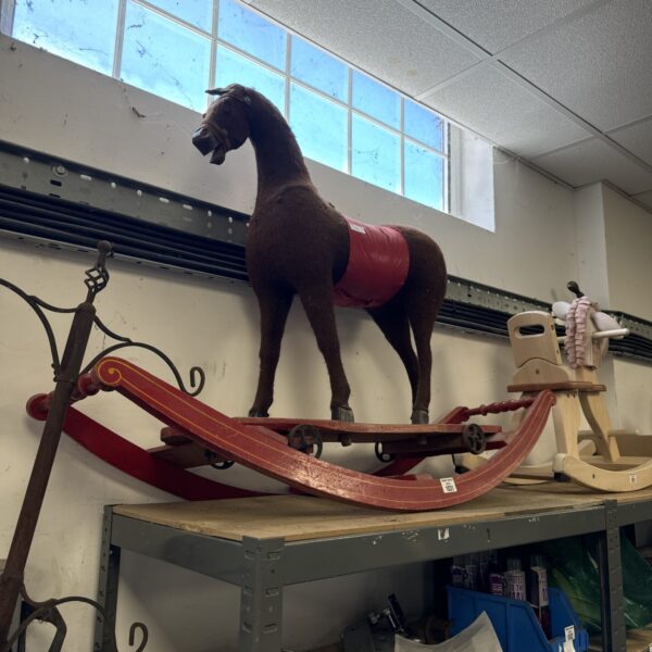 Brown and red vintage rocking horse, classic children’s toy.