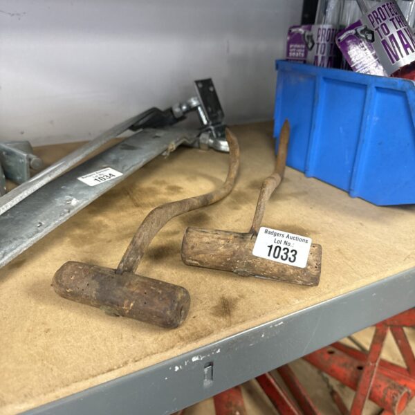 Pair of vintage hay hooks for farm work.