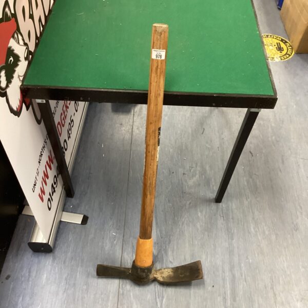 Vintage matock digging tool with wooden handle.