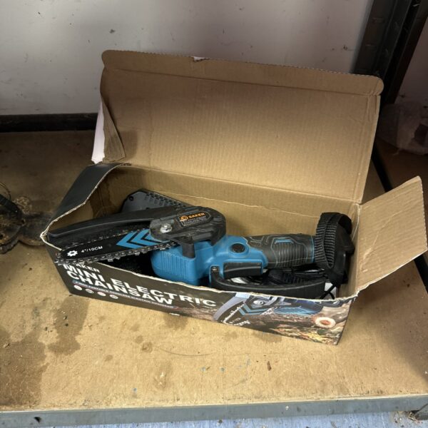 Used Saker mini 4” cordless electric chainsaw for auction.