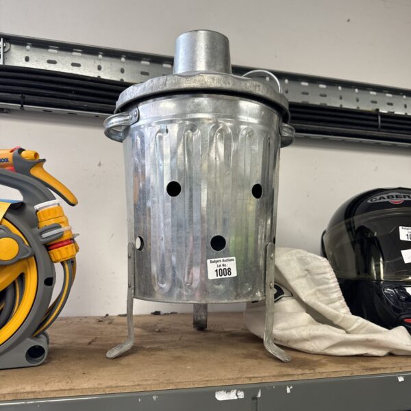 Small metal garden fire bin for outdoor use.