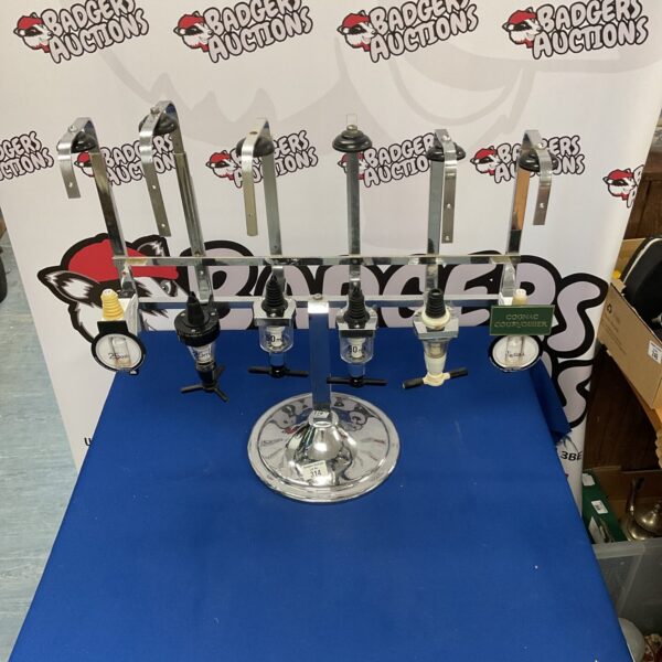 Set of six bar optics for dispensing spirits at a bar.
