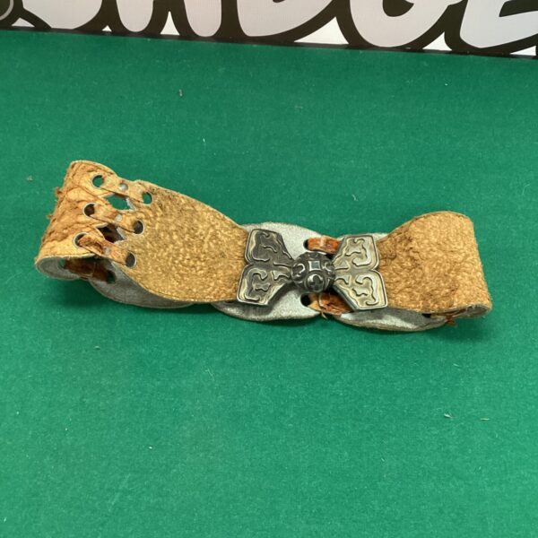 Vintage decorative leather belt with floral tooling and embossed details.