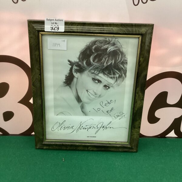 Framed signed photograph of Olivia Newton-John, a collectible celebrity item.