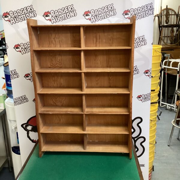 Vintage oak shelving unit with four tiers for display.