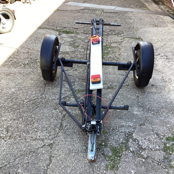 Motorcycle trailer with light board for single bike transport.