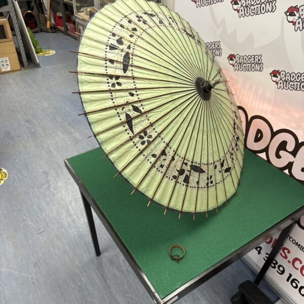 Vintage Japanese paper parasol with floral design on display.