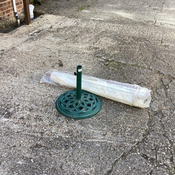Metal garden parasol stand with decorative base for outdoor use.