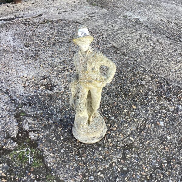 Vintage garden boy statue, weathered cast stone ornament.