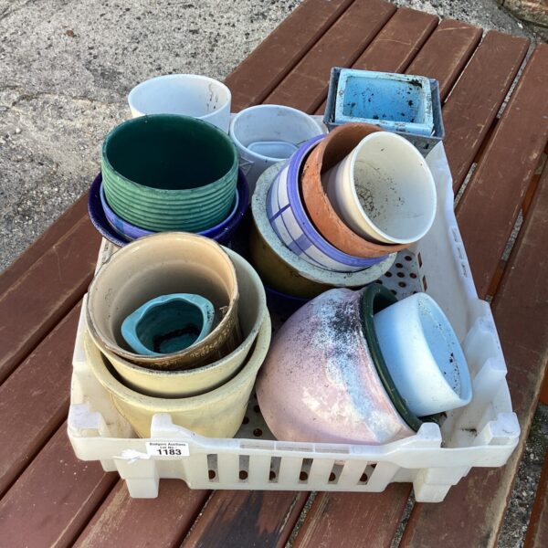 Assortment of glazed and terracotta garden pots for plants.