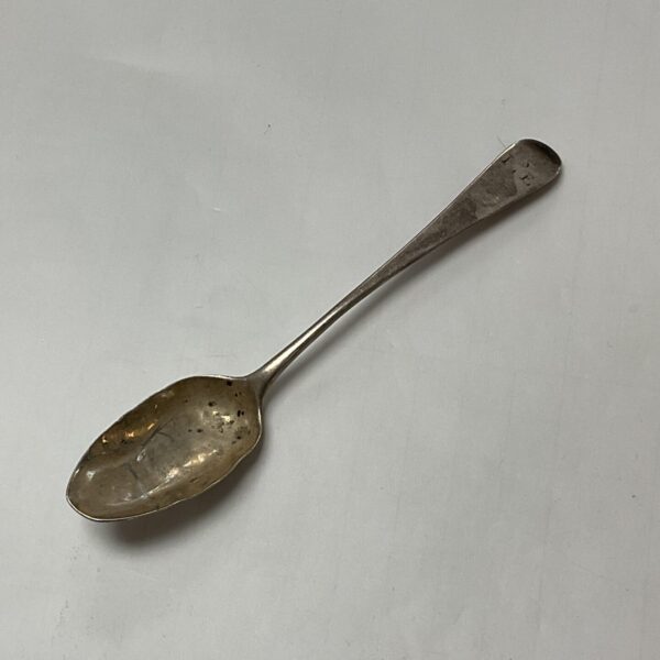Antique Georgian silver teaspoon with shaped handle.