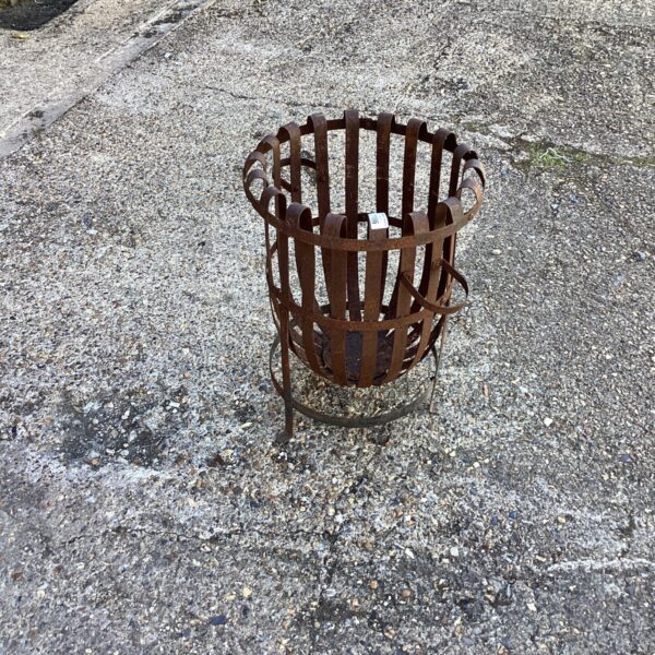 Rustic iron garden fire pit for outdoor heating and ambiance.