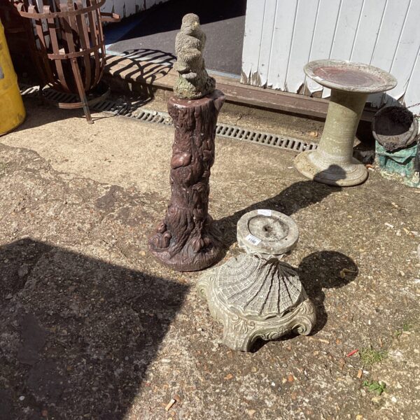 Weathered vintage stone garden plant pot stand for outdoor display.
