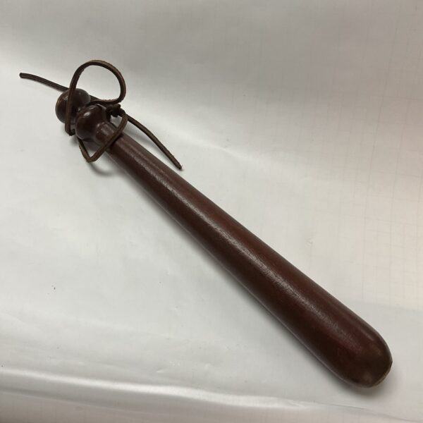 Vintage wooden police truncheon with leather strap.