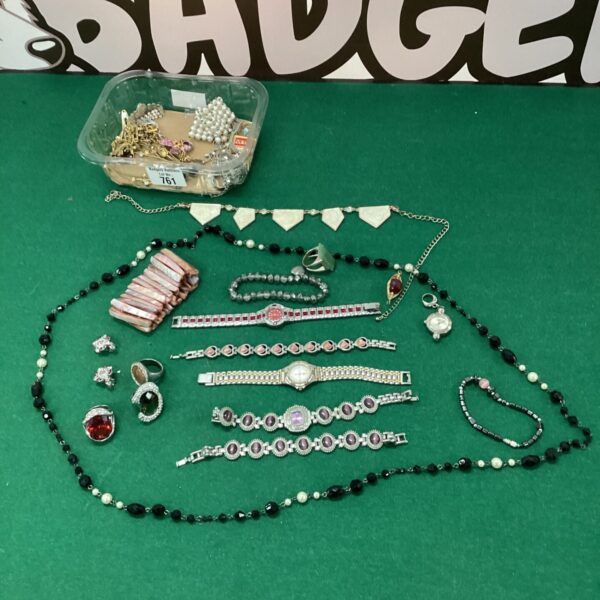 Tub of assorted costume jewellery pieces for sale.
